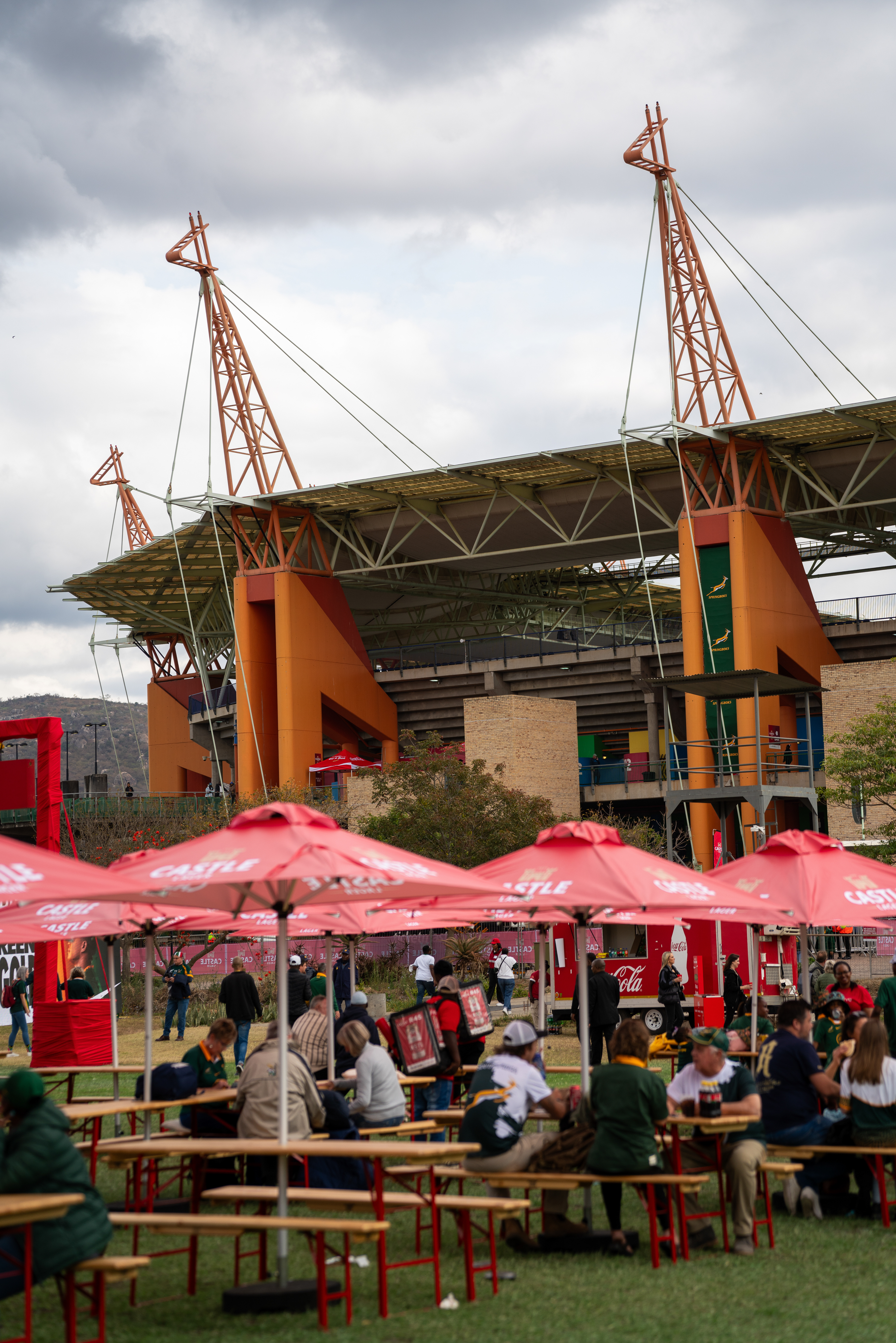 Professional Castle Lager gazebo setup at sports stadium with large crowd