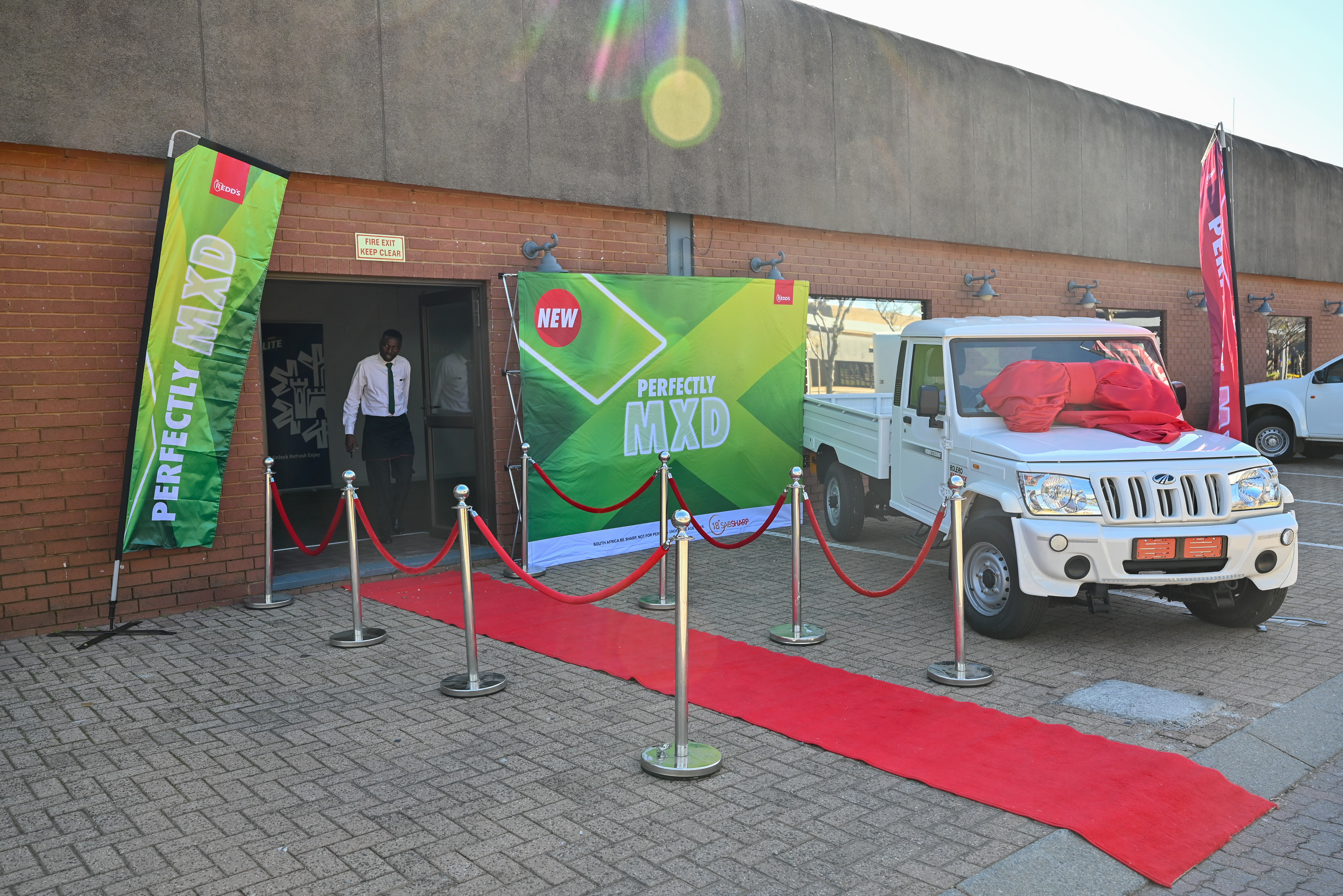 Perfectly MX'D banner wall display with red carpet entrance at promotional event